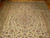 10' x 16'6" Persian Kashan rug showing small center rosette and multi-band floral border