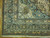Corner detail showing salmon spandrel, navy floral main border and soft teal ground of the Mahal design