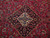 Close-up of ivory and navy diamond medallion surrounded by rose, cornflower blue and green floral sprays