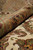 Rolled edge showing olive border pile depth beside the cream field and knots per square inch