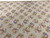 End view of the 10 x 14 needlepoint rug showing repeating diamond lattice and bouquets