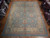 Large 11 by 15 hand-knotted Oushak rug photographed from above showing pale blue field