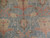 Close-up of blue field with coral vines, ivory palmettes and olive cartouches in wool