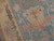 Ivory main border with olive vinework meeting the dusty blue field of this Turkish rug