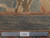 Back of the rug beside a ruler showing knot density, fringe and Authentic Handmade tag