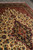 Close view of the navy medallion and cream field scattered with red and blue blossoms