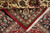 7x10 Persian Kashan rug folded back to show knot density and cotton fringe
