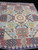 11'10" x 14'7" Chobi Peshawar Mamluk rug photographed at an angle showing full compartment field