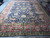 Showroom floor view of oversized 10x15 navy blue hand-knotted Oriental area rug