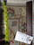 Close-up of the fine wool and silk pile beside a tape measure and F-5063 rug tag