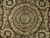 Close-up of the round floral center medallion with crown motifs and dense cream flower scrollwork