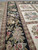 Detail of the wide black border beside ivory cameo squares holding pastel flower bouquets