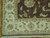 Corner detail of ivory guard borders, rosette motifs and hand-tied cotton fringe on the 10x14 wool rug