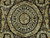 Close-up of circular medallion with cream roses and scrolling vines on espresso brown ground