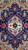 Navy geometric medallion close up with ivory center rosette and bright pink outline in wool