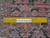 Ruler laid across the weave to show knot count, with Authentic Handmade verification label visible