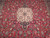 Ivory lobed medallion and dense all-over floral vine work on the deep red Kashan field