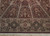 Arched vault panels meeting the floral border, showing fine wool and silk pile and fringed end
