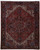 Full overhead view of 8'2" x 10'2" Persian Heriz rug with red field and ivory corners