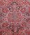 Close-up of the stepped geometric medallion with olive petals and sky blue rosette center