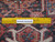 Back of the 8x10 Heriz rug with ruler showing hand-knotted wool knot density and cotton warps
