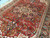 Angled view of the 8 lobed navy medallion, serrated leaves and antique red open field