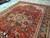 Persian Heriz medallion seen from the side, camel center, coral petals and olive green leaves