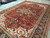 8'2 x 11'6 red Persian Heriz viewed from one end, medallion, spandrels and navy border
