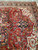 Red field close up with curled vine, olive leaves and ivory corner medallion drawing
