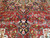 Angled pile detail showing navy palmette pendant, camel outlines and dense antique red ground