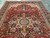 8'2 x 11'6 Heriz rug angled on grey tile, showing the full geometric layout