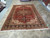 Full length view of this 1970s Heriz wool rug in the Freeport showroom aisle