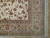 Corner detail showing multi-band taupe border, ivory guard stripes and hand-tied cotton fringe