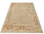 Neutral greige room size Oushak rug photographed from the corner with olive and blush blossoms