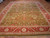 10x15 hand-knotted Indian Agra rug displayed on parquet floor, olive field and coral borders