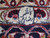 Woven signature cartouche in the ivory border of this signed Kashmar rug, Persian script visible
