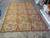 Full length view of the 11x15 flat weave needlepoint rug showing three columns of oval panels