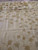 Muted beige inner field with scattered vine leaves and thin tendrils, low flat weave texture