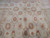 Field detail with coral rosettes, ivory vine lattice and light storage fold lines that relax flat