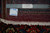 9'9" x 13'5" rug reverse showing tight hand knotted wool weave, ruler and authenticity tag