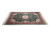 Low angle of 6x9 green area rug lying flat with ivory fringe at both ends