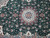 Medallion detail with taupe cartouche ring, blue petals and scrolling floral field around it