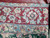 Reverse side of the rug showing tight knotting and clear red border pattern