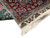Folded corner revealing green selvage, cream fringe and ivory floral end panel detail