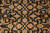 Close-up of the all over field pattern, cream rosettes and rust vines on deep black ground
