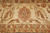 Ivory border medallion flanked by large leaf forms in rust, olive and gold, close view