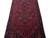 5x14 Persian Hamedan runner detail: stepped navy spandrels, salmon rosettes and serrated leaves on red