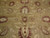 Close-up of all-over palmette and vine design in sage green, burgundy and ivory wool