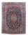 Navy Persian Kashan rug with red lobed medallion, ivory floral field and layered borders, shown flat
