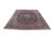 10x13 Kashan rug photographed at an angle on white, showing navy field and ivory fringe
